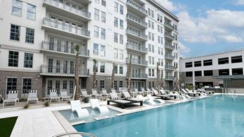 Wet deck lounge with cabanas, lounge chairs and day beds